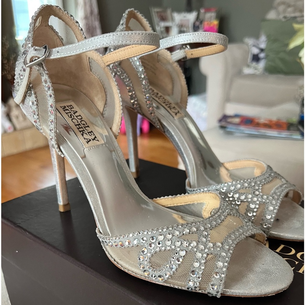 Badgley Mischka dress sandals. The model is Tansy. Color-silver with rhinestones